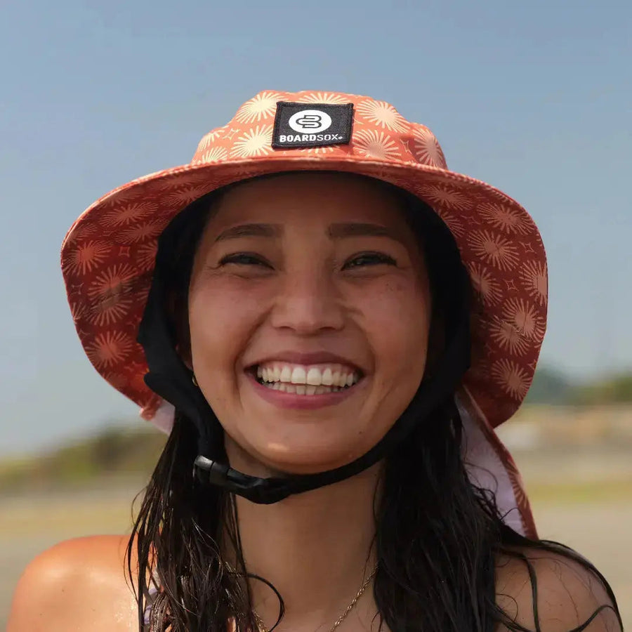 Sunny Beachley Boardsox surf hat in cream with a soft orange print with hard shell insert